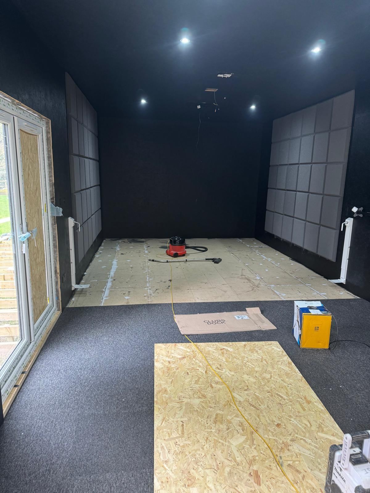Golf simulator room acoustic panels and black-out finish — Crowthorne Construction
