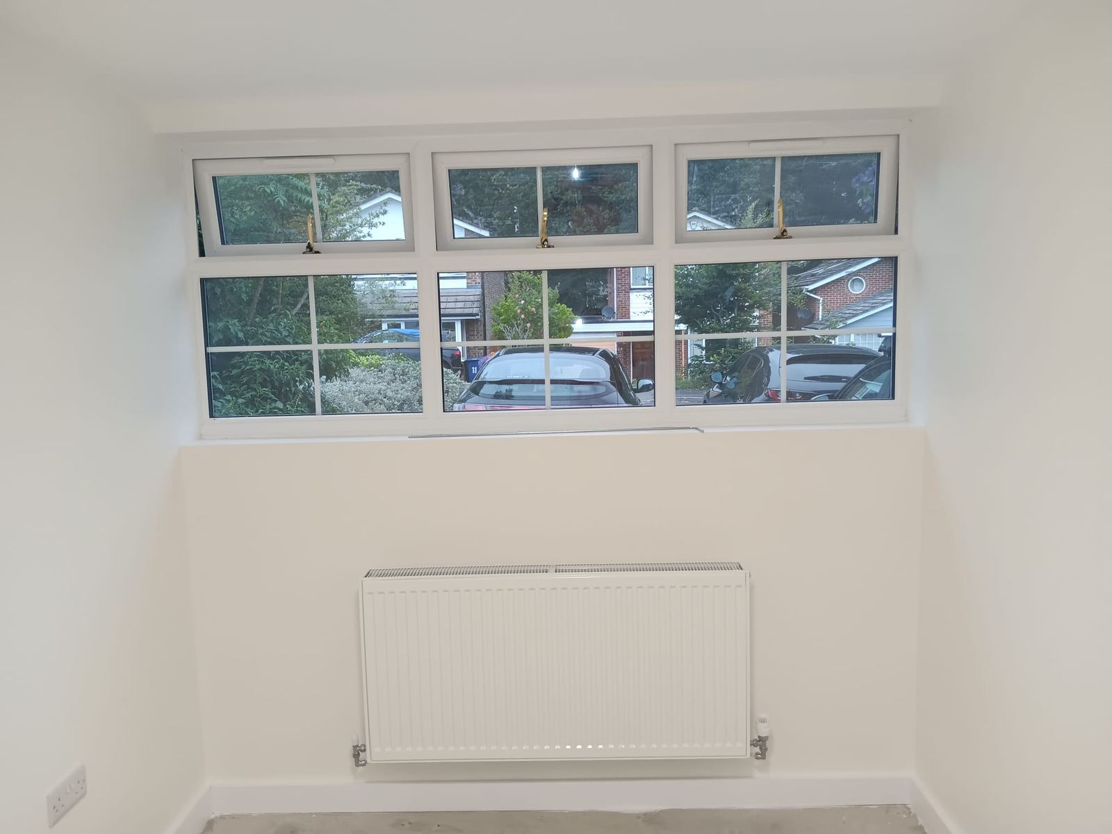 New triple window installation inside converted garage — Crowthorne Construction