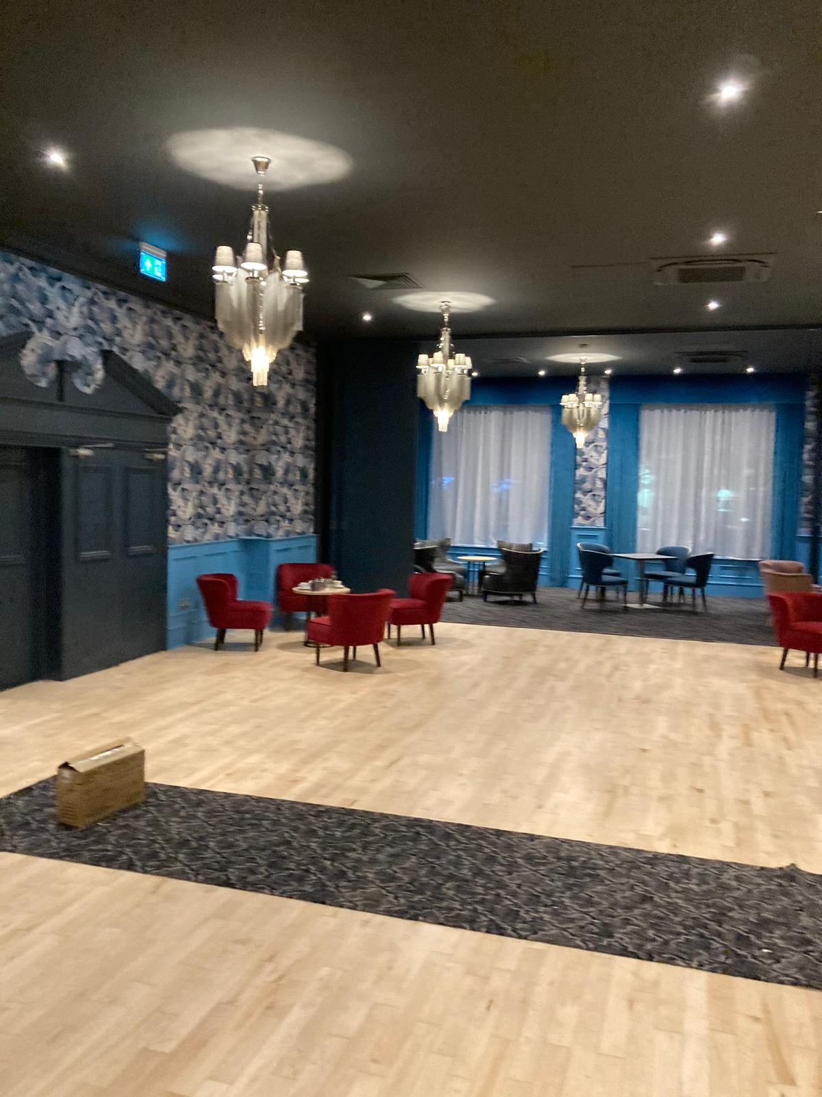 Completed hotel dining room with chandeliers and feature panelling — Crowthorne Construction